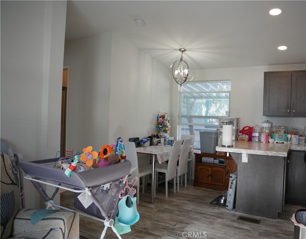 6545 Wilbur, Unit 39 Reseda, CA 91335 - Photo 8 of 27 a view of a dining room with furniture and chandelier