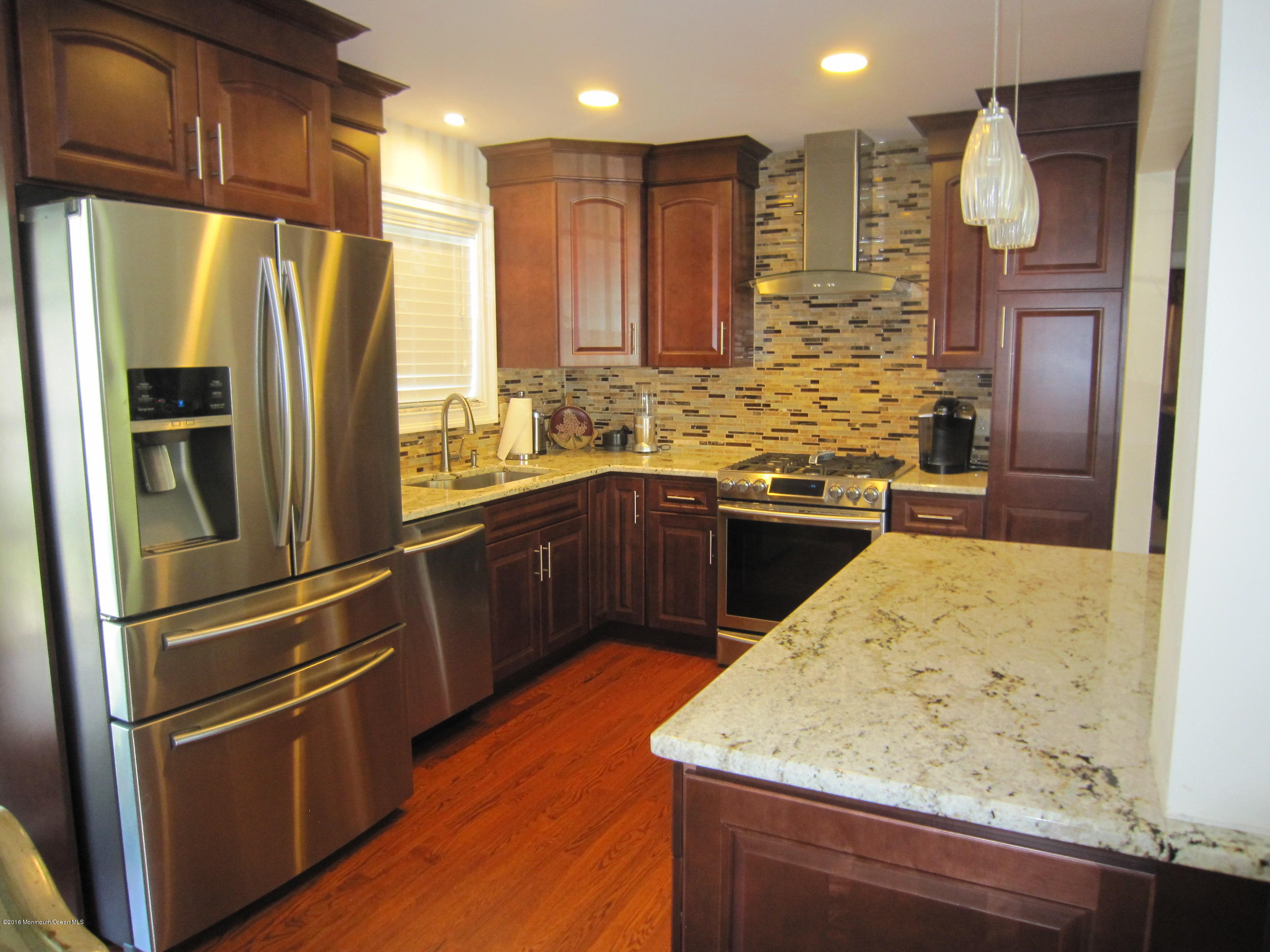 158 Newbury Road Howell, NJ 07731 - Photo 4 of 19 a kitchen with stainless steel appliances granite countertop a refrigerator a sink and wooden cabinets
