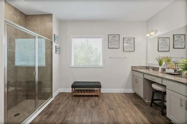 a en suite bathroom with a shower and a sink