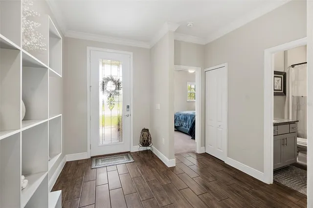 a view of a room with wooden floor and windows