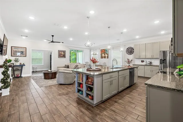 a kitchen with counter top space and wooden floor