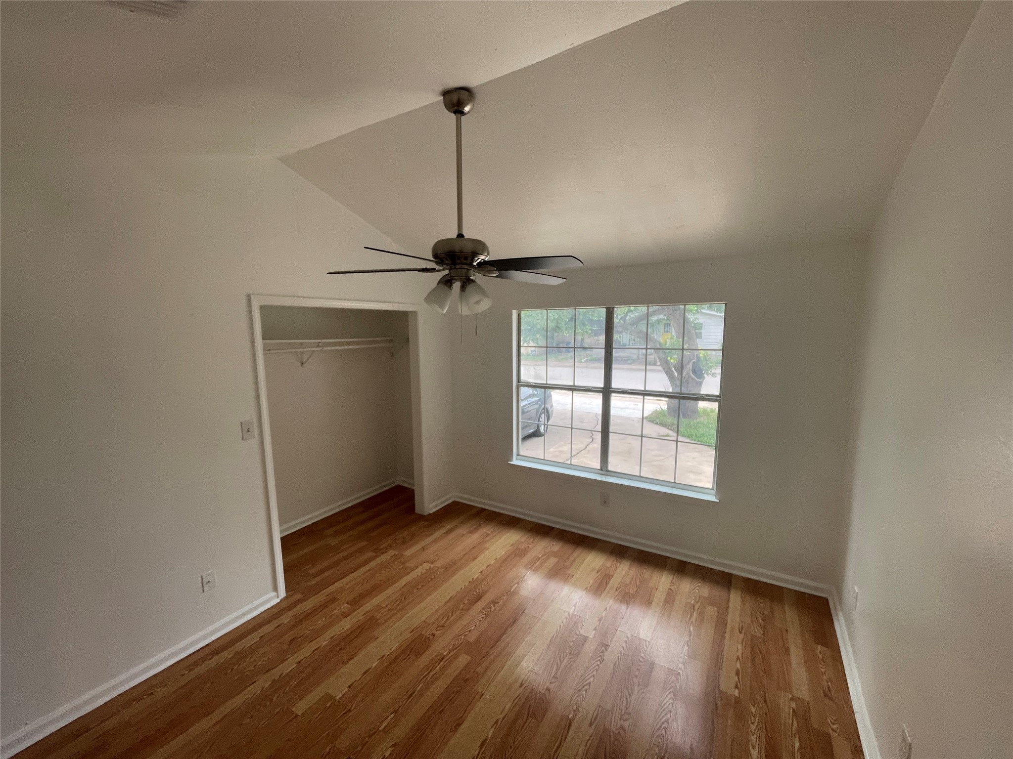 2808 Lyons Road, Unit A Austin, TX 78702 - Photo 4 of 12 a view of an empty room with a window and wooden floor