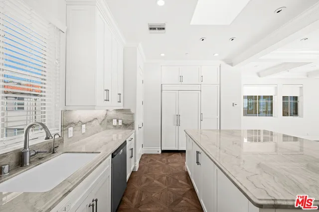 a large white kitchen with a large window