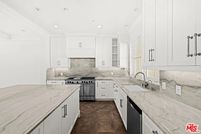 a kitchen with stainless steel appliances granite countertop a sink stove and cabinets