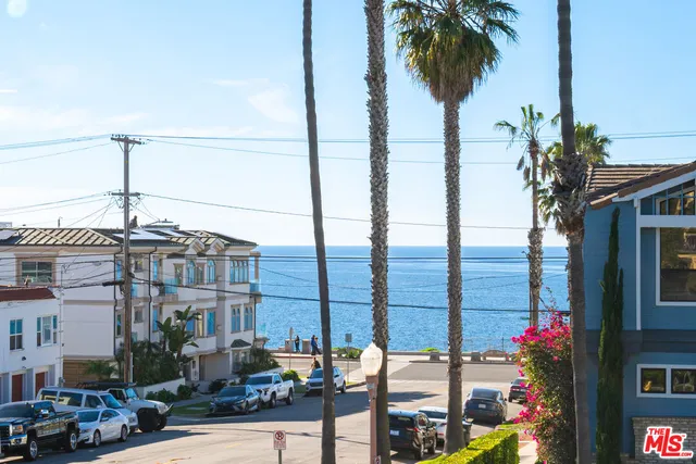 a front view of multiple building with palm tree
