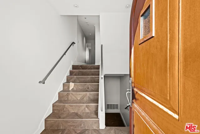a view of staircase with white walls and a window