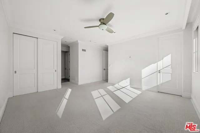 a bedroom with a bed and a ceiling fan