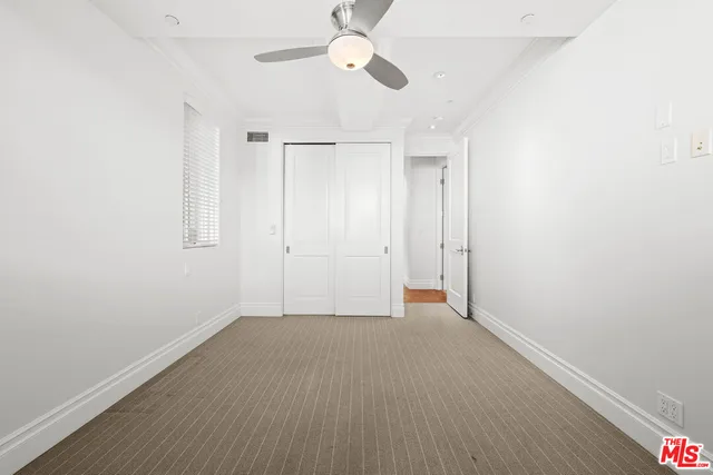 a view of an empty room with a fan