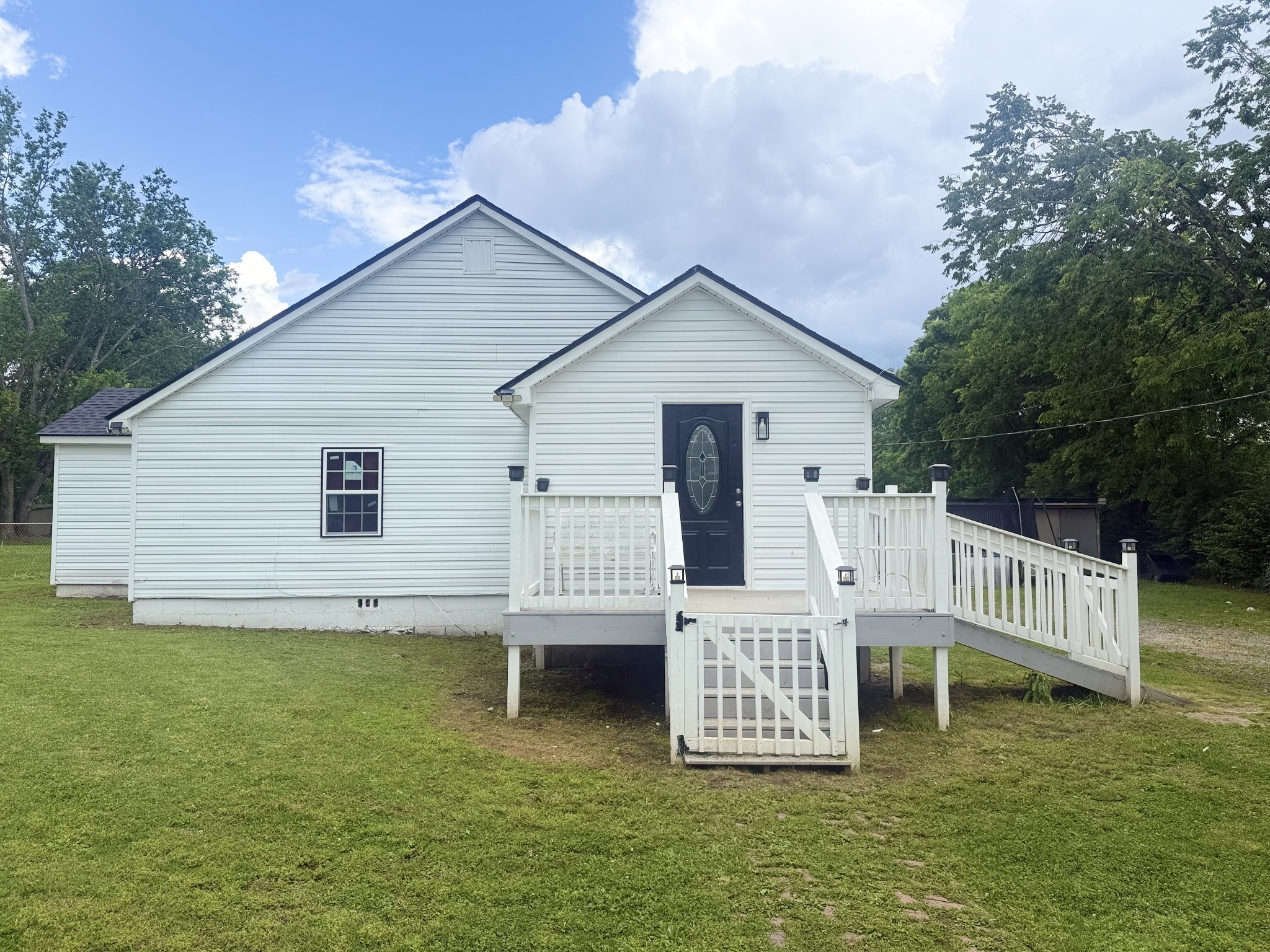 a view of a house with a yard deck and a garden