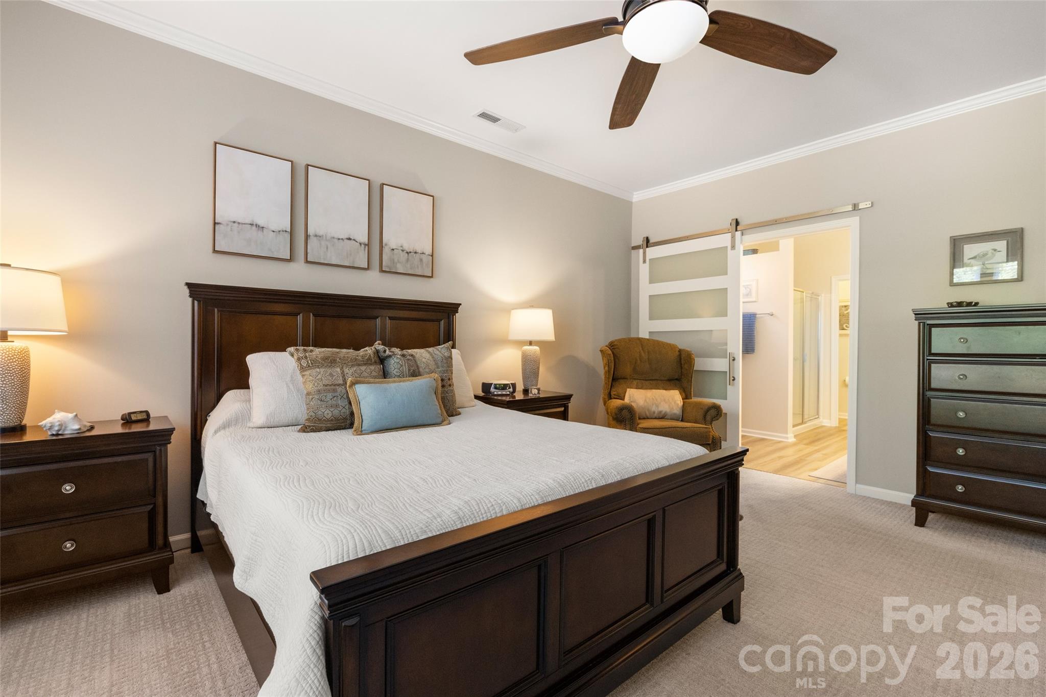 1002 Falling Leaf Street Indian Land, SC 29707 - Photo 17 of 45 a bedroom with a bed and a chandelier