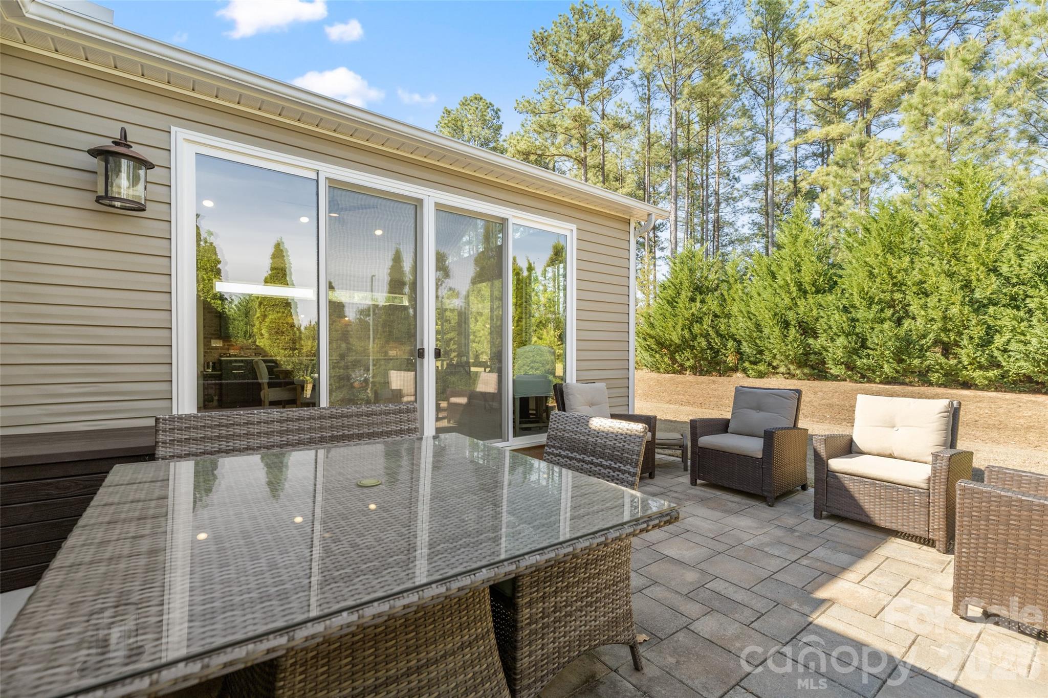 1002 Falling Leaf Street Indian Land, SC 29707 - Photo 27 of 45 a view of a patio with couches and table and chairs with wooden floor and fence