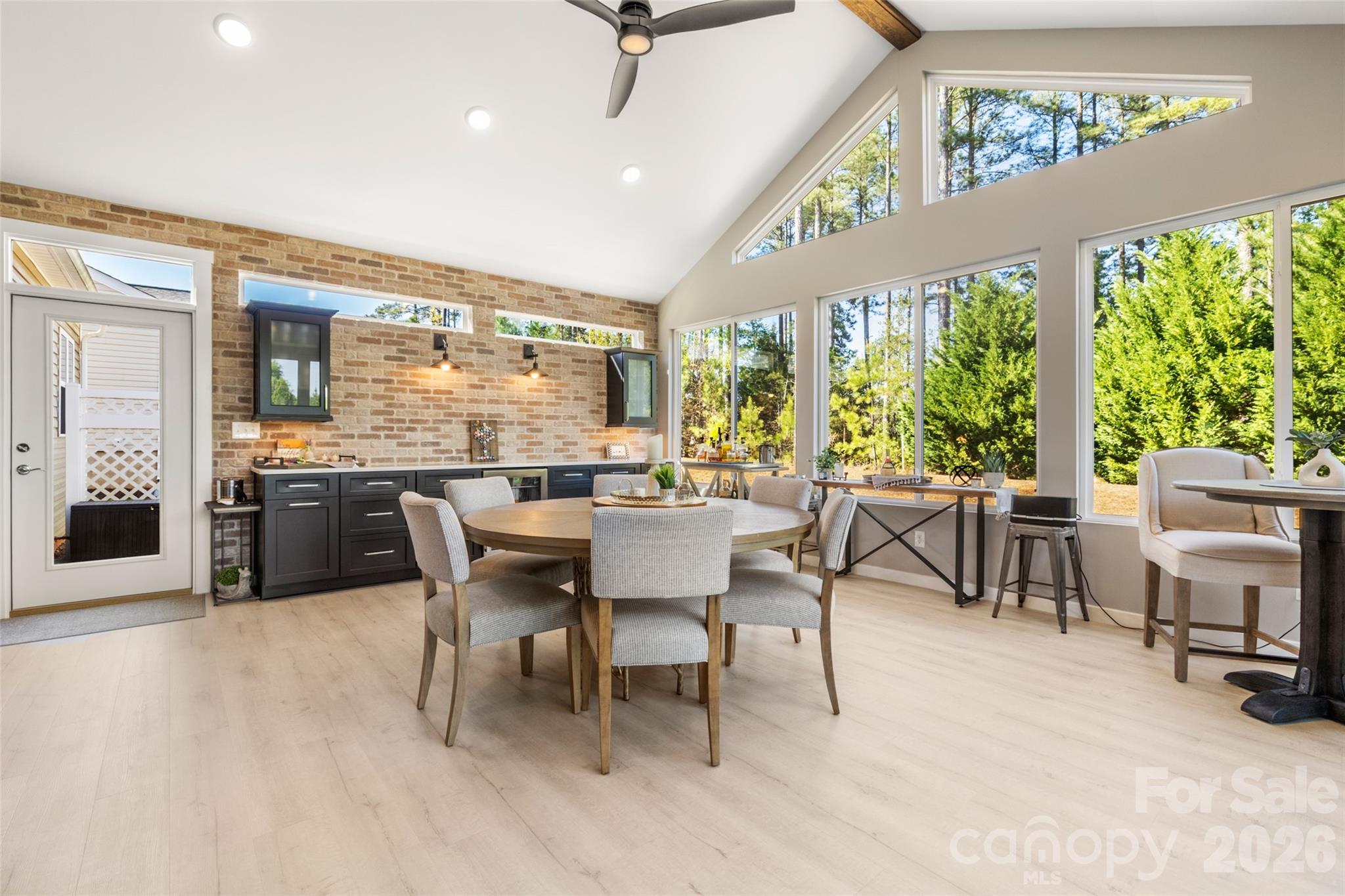 1002 Falling Leaf Street Indian Land, SC 29707 - Photo 3 of 45 a dining room with furniture a floor to ceiling window and a ceiling fan