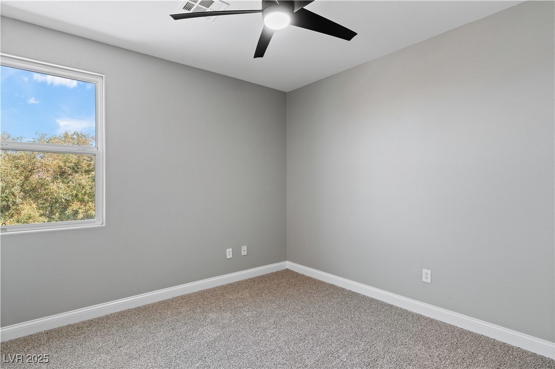 312 Pocono Ranch Avenue North Las Vegas, NV 89031 - Photo 25 of 34 Unfurnished room with baseboards, ceiling fan, and carpet flooring