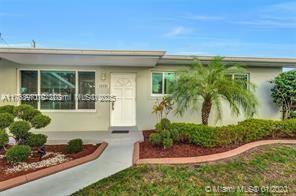 5391 West 9th Lane Hialeah, FL 33012 - Photo 1 of 22 a front view of a house with garden