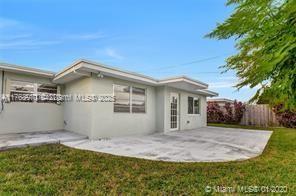 5391 West 9th Lane Hialeah, FL 33012 - Photo 11 of 22 a front view of house with yard and trees in the background
