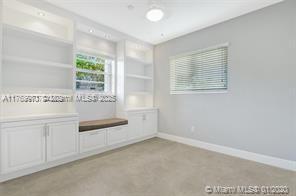 5391 West 9th Lane Hialeah, FL 33012 - Photo 14 of 22 a view of kitchen with granite countertop white cabinets and outdoor view