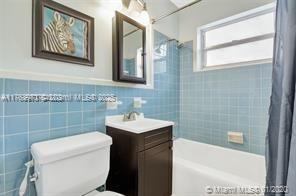 5391 West 9th Lane Hialeah, FL 33012 - Photo 19 of 22 a bathroom with a sink a toilet and shower