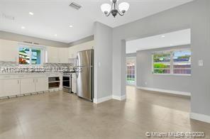 5391 West 9th Lane Hialeah, FL 33012 - Photo 21 of 22 a kitchen with stainless steel appliances granite countertop a refrigerator and a sink