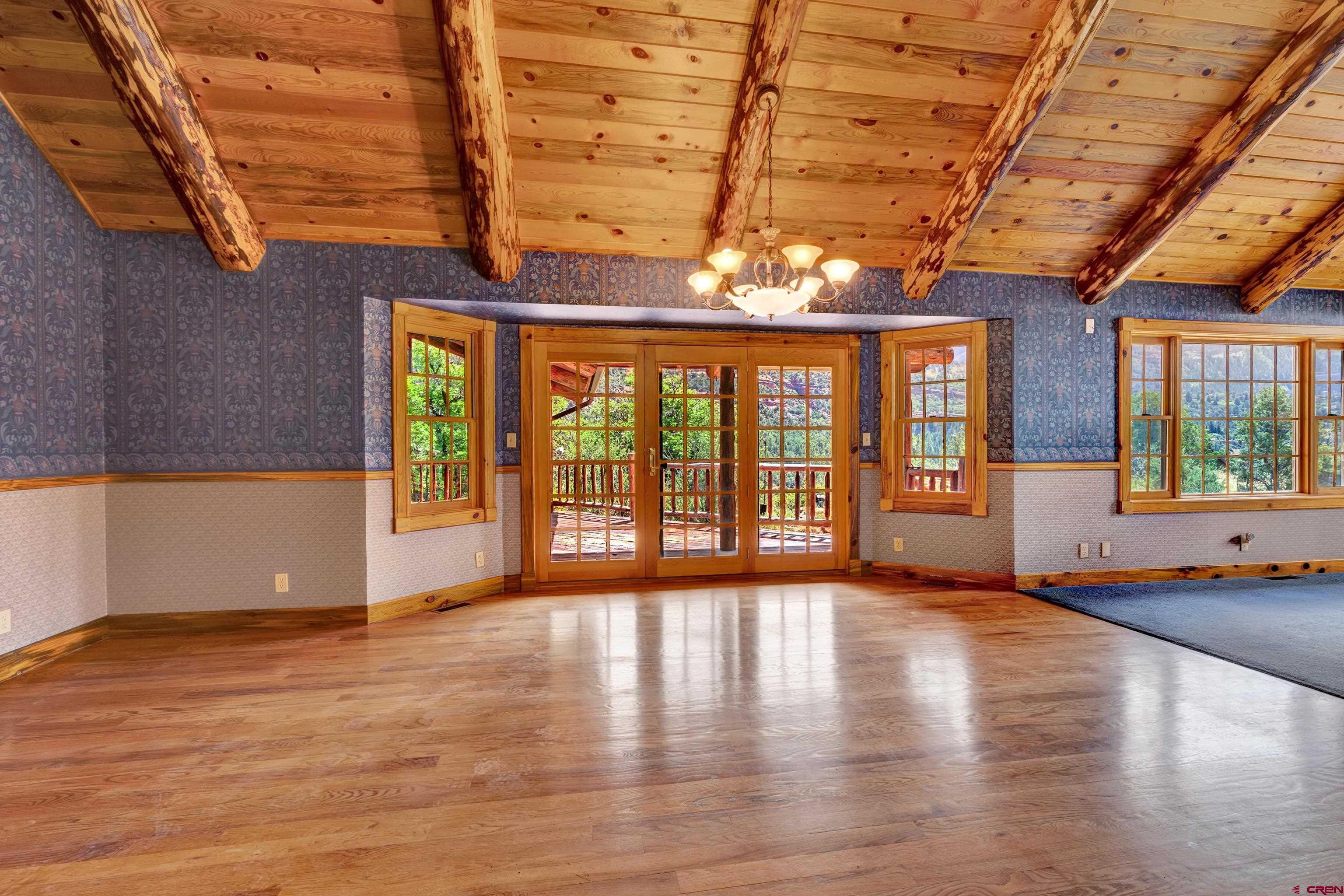 2692 County Road 17 Ridgway, CO 81432 - Photo 8 of 38 a view of an empty room with wooden floor and a window