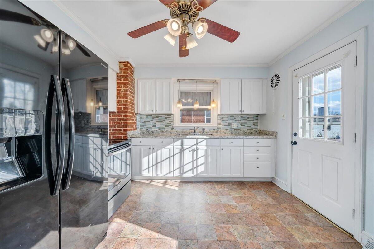 2346 Berkley Avenue Southwest Roanoke, VA 24015 - Photo 15 of 50 a kitchen with granite countertop a stove a sink and a refrigerator with wooden floor
