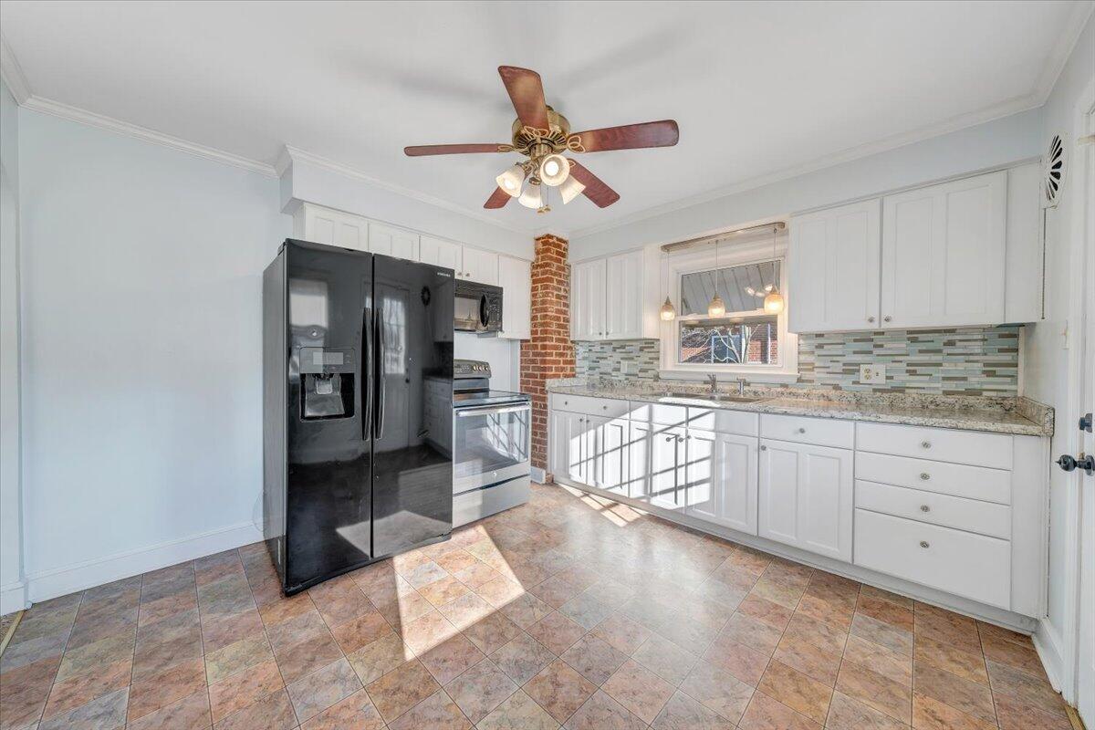 2346 Berkley Avenue Southwest Roanoke, VA 24015 - Photo 16 of 50 a kitchen with stainless steel appliances a refrigerator sink and cabinets