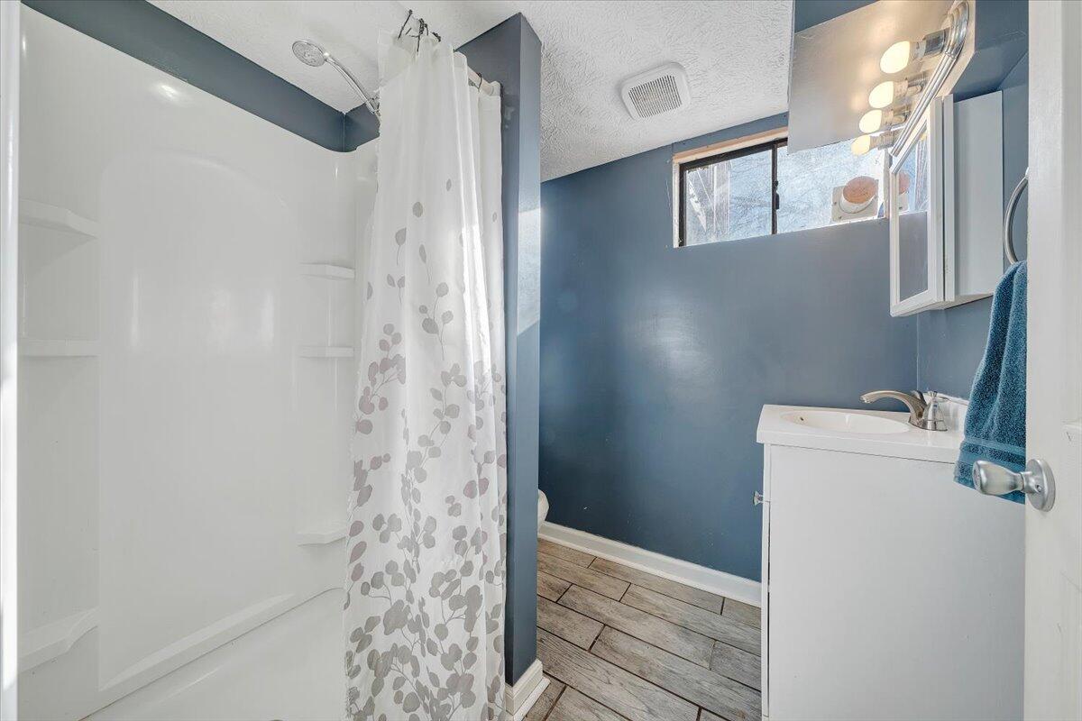 2346 Berkley Avenue Southwest Roanoke, VA 24015 - Photo 29 of 50 a bathroom with a shower and a sink