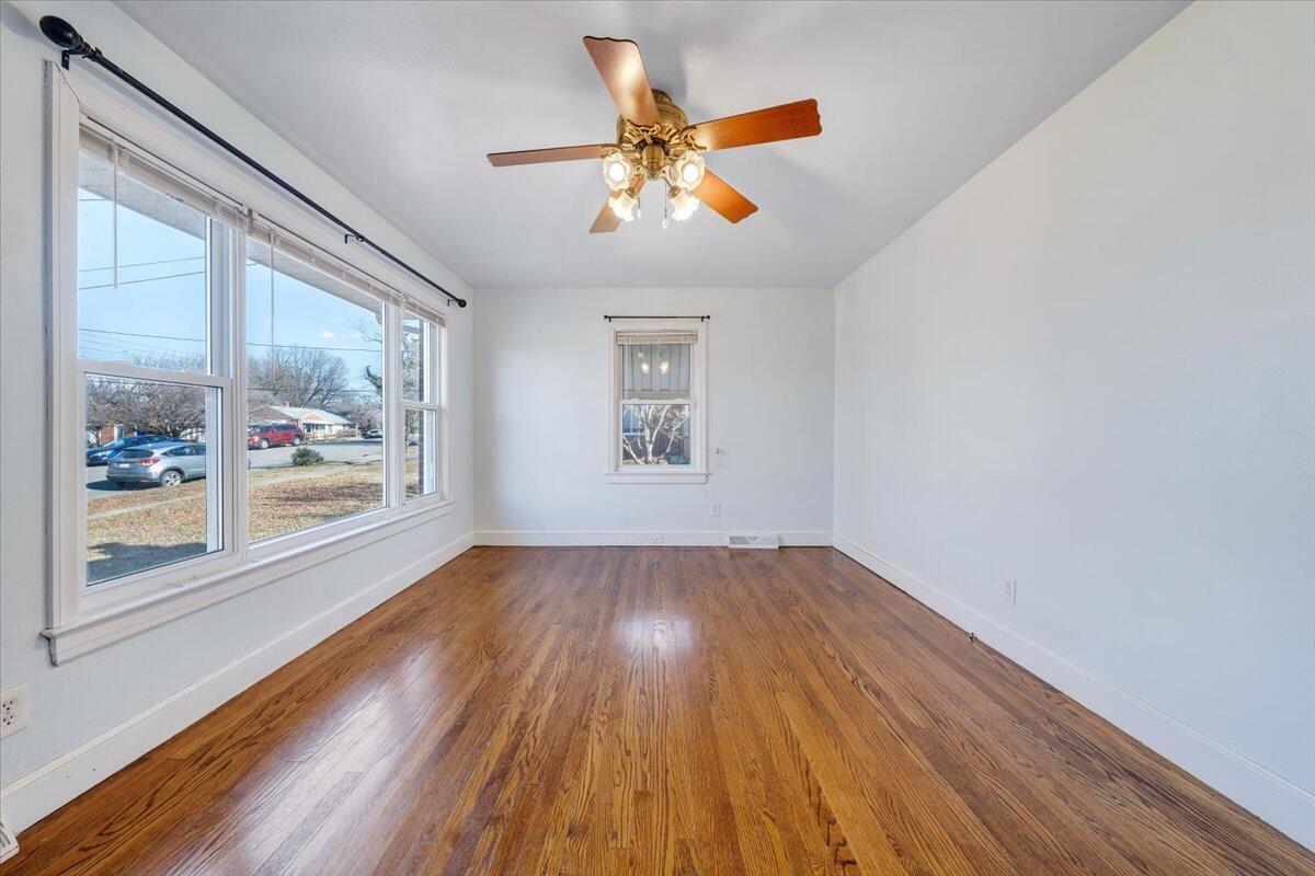 2346 Berkley Avenue Southwest Roanoke, VA 24015 - Photo 6 of 50 a view of an empty room with wooden floor and a window