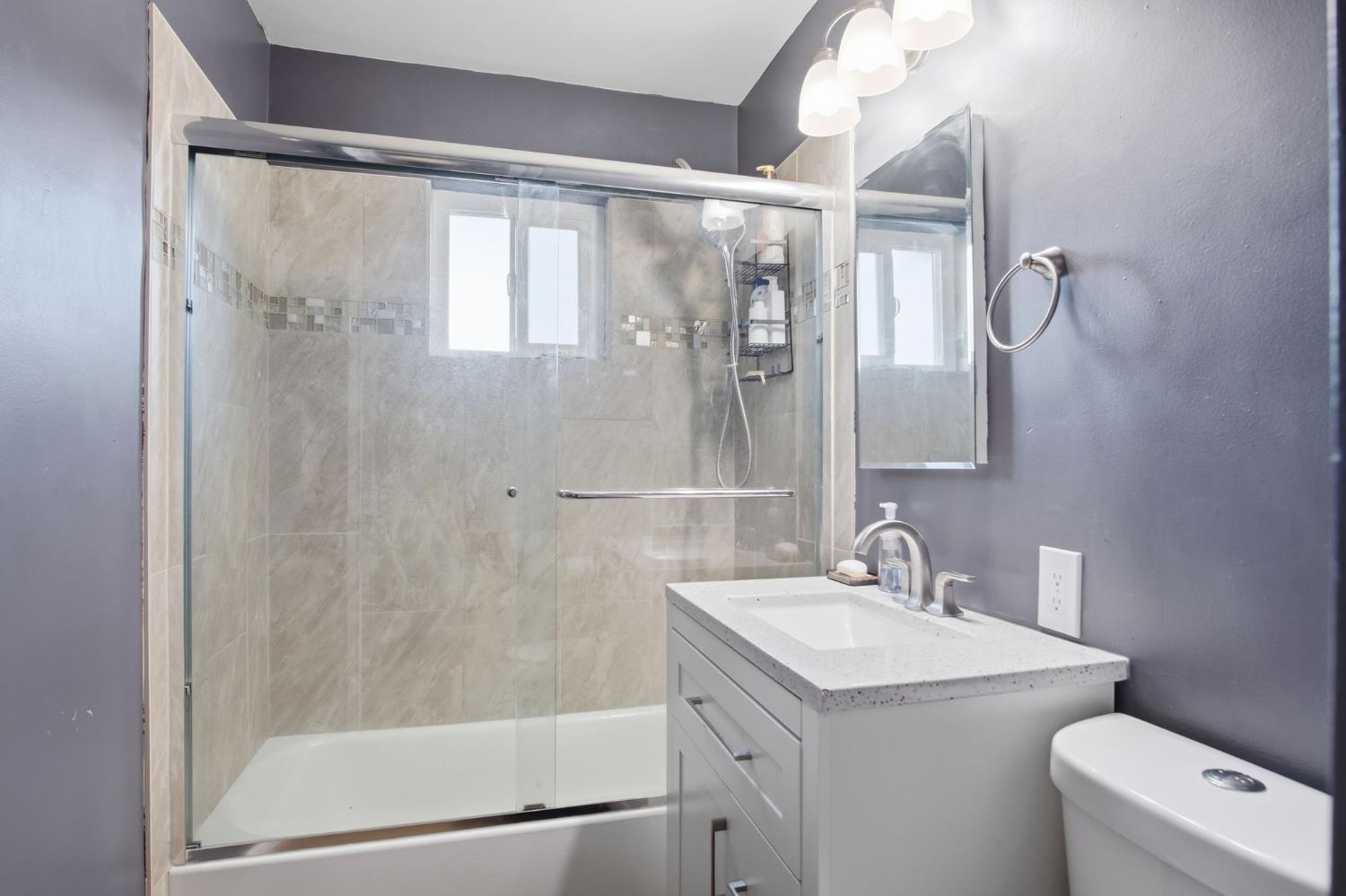 355 Harding Avenue Manteca, CA 95336 - Photo 11 of 21 a bathroom with a granite countertop sink toilet and shower