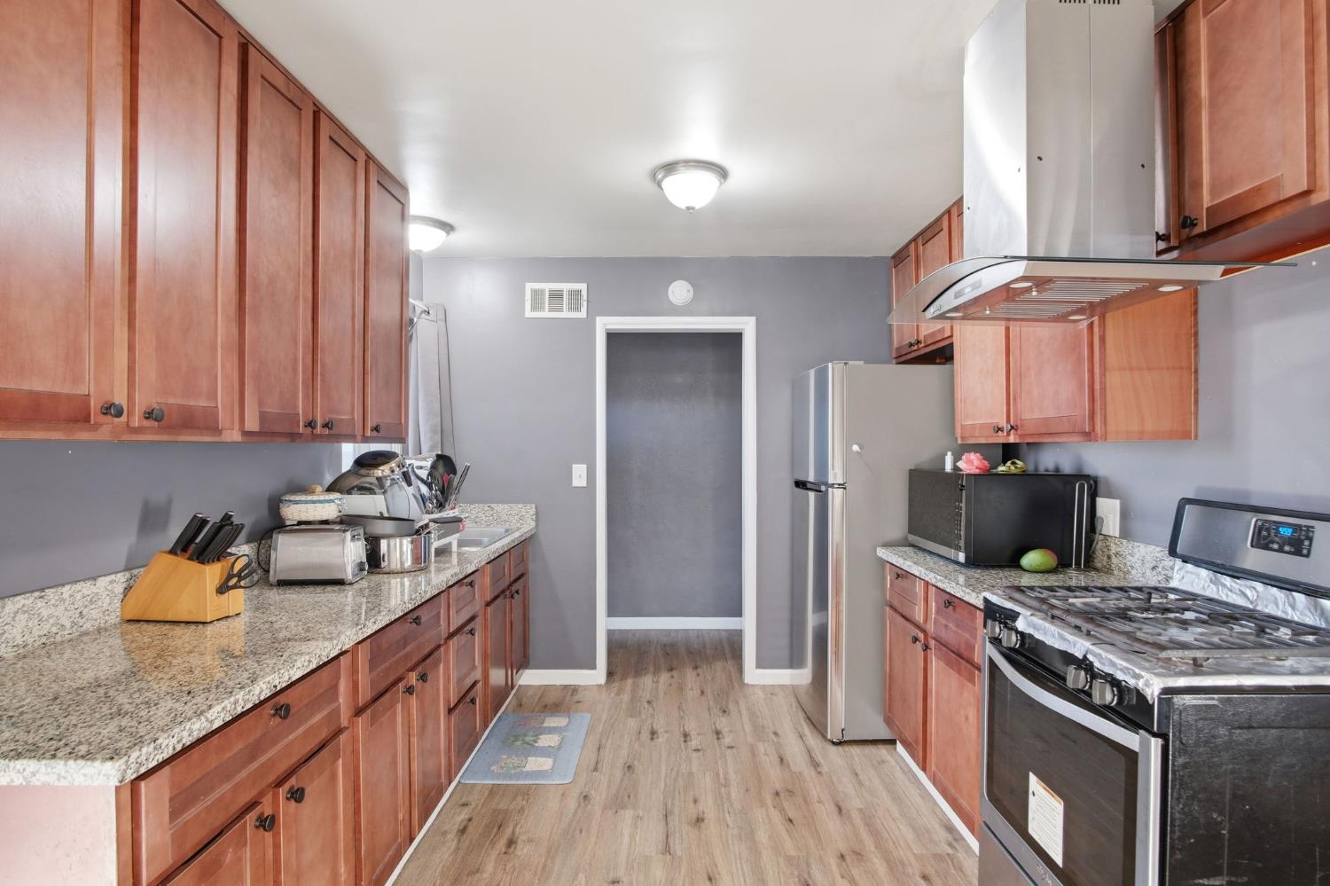 355 Harding Avenue Manteca, CA 95336 - Photo 7 of 21 a kitchen with stainless steel appliances granite countertop a sink stove and cabinets