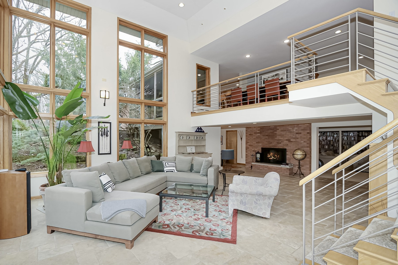 363 Bateman Road Barrington Hills, IL 60010 - Photo 8 of 40 a living room with furniture a fireplace and a floor to ceiling window