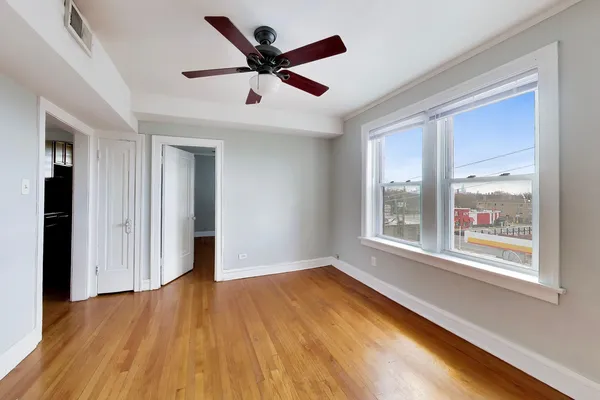 a view of a livingroom with a ceiling fan and window