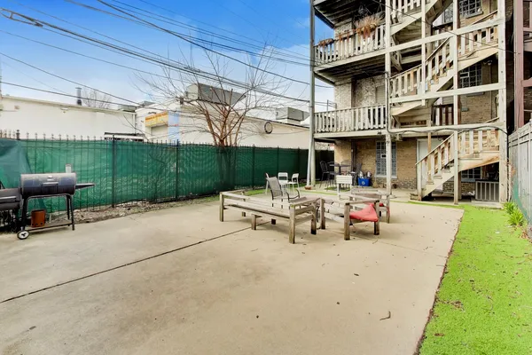 a view of a patio with a table and chairs