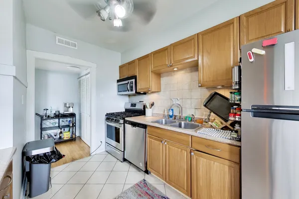 a kitchen with a sink cabinets and appliances
