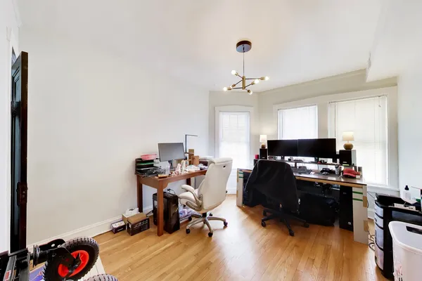 a view of a workspace with furniture and a window