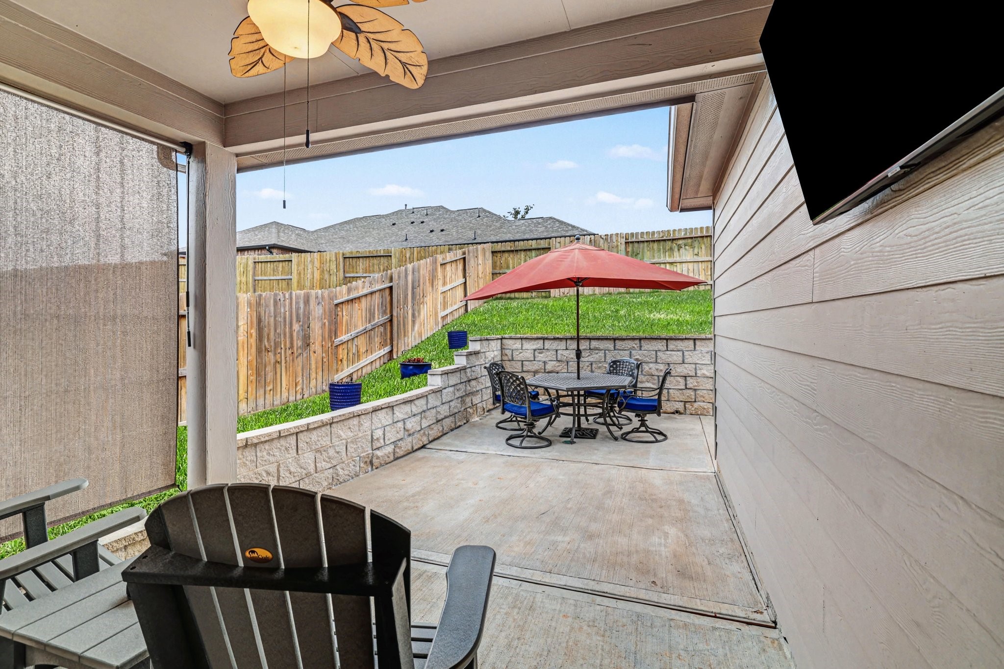 320 Red Maple Lane Conroe, TX 77304 - Photo 18 of 24 Covered patio extends to a wrap-around terrace with tiered stone retaining wall.