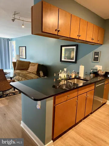 a living room with granite countertop couches a fireplace with wooden floor