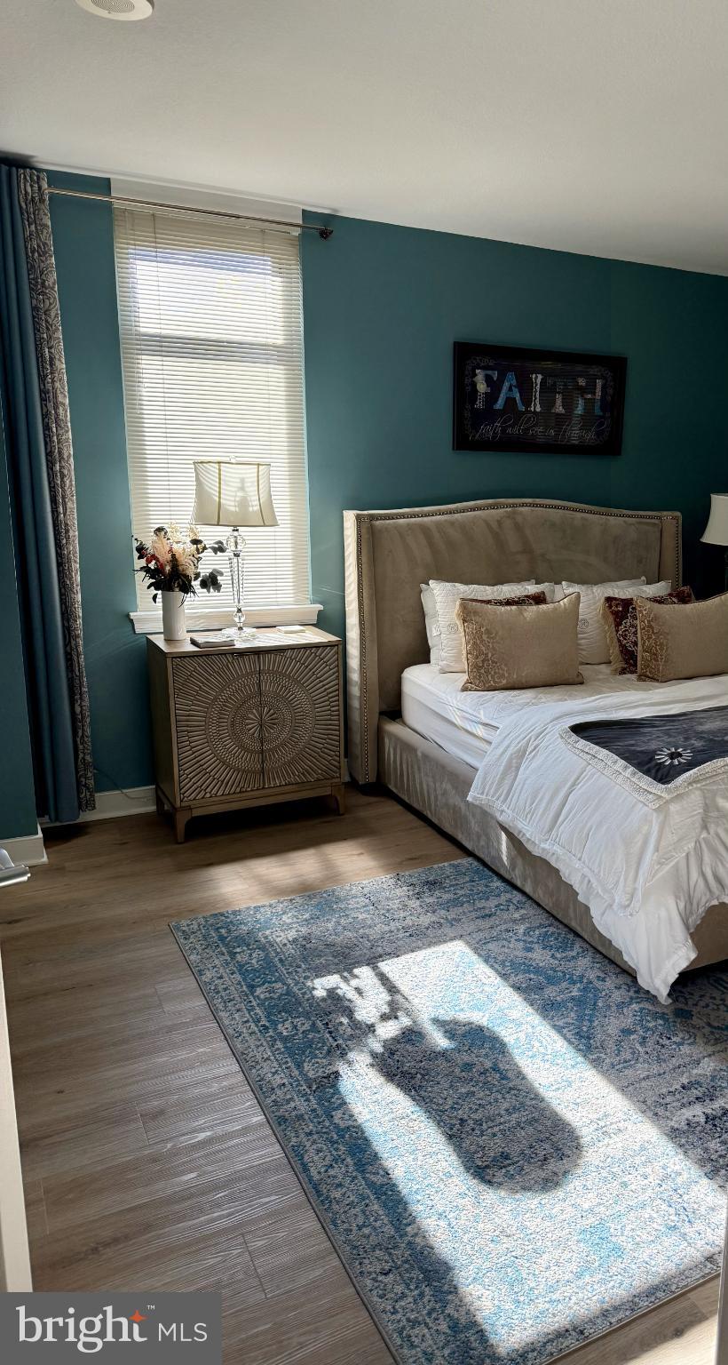 1117 10th Street Northwest, Unit 301 Washington, DC 20001 - Photo 16 of 38 a living room with furniture and a wooden floor