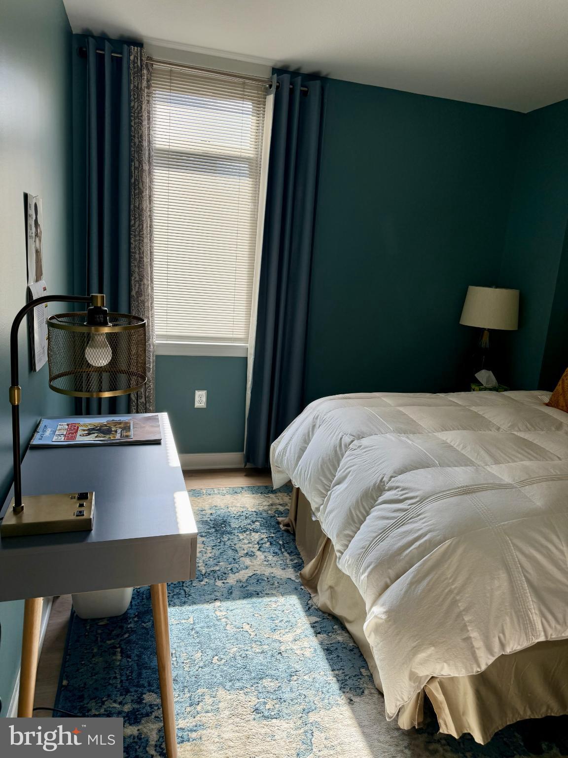 1117 10th Street Northwest, Unit 301 Washington, DC 20001 - Photo 5 of 38 a bedroom with a bed a mirror and a window