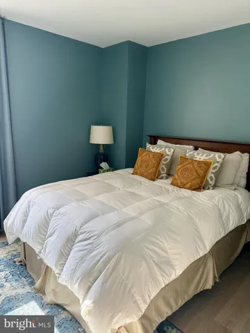 a large bed sitting in a bedroom next to a wooden cabinet