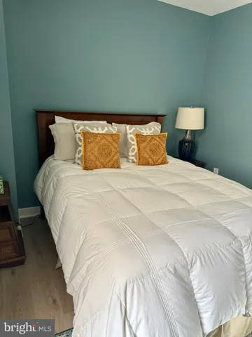a large bed sitting in a bedroom next to a lamp