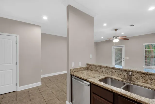 a kitchen with a sink and a refrigerator