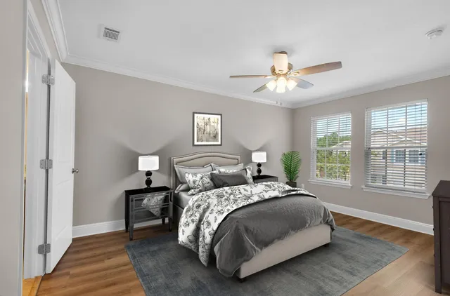 a bedroom with a bed and a chandelier