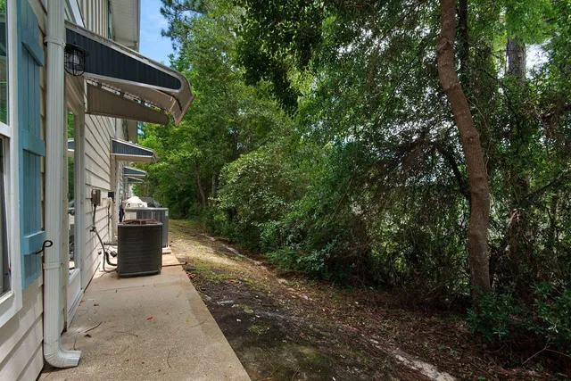 a view of a pathway of a house with a yard