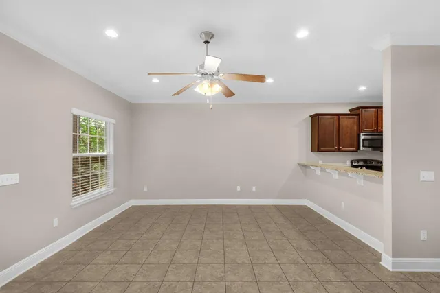 a view of a livingroom with a computer on the desk and a window