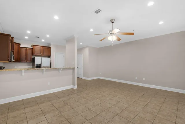 a view of kitchen with refrigerator and ceiling fan