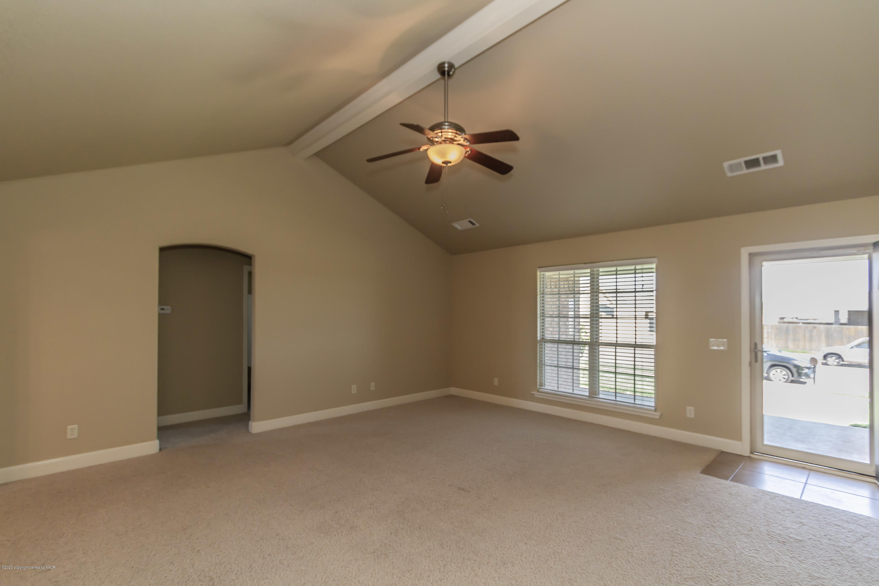 3813 Arden Road Amarillo, TX 79118 - Photo 7 of 33 an empty room with chandelier fan and windows