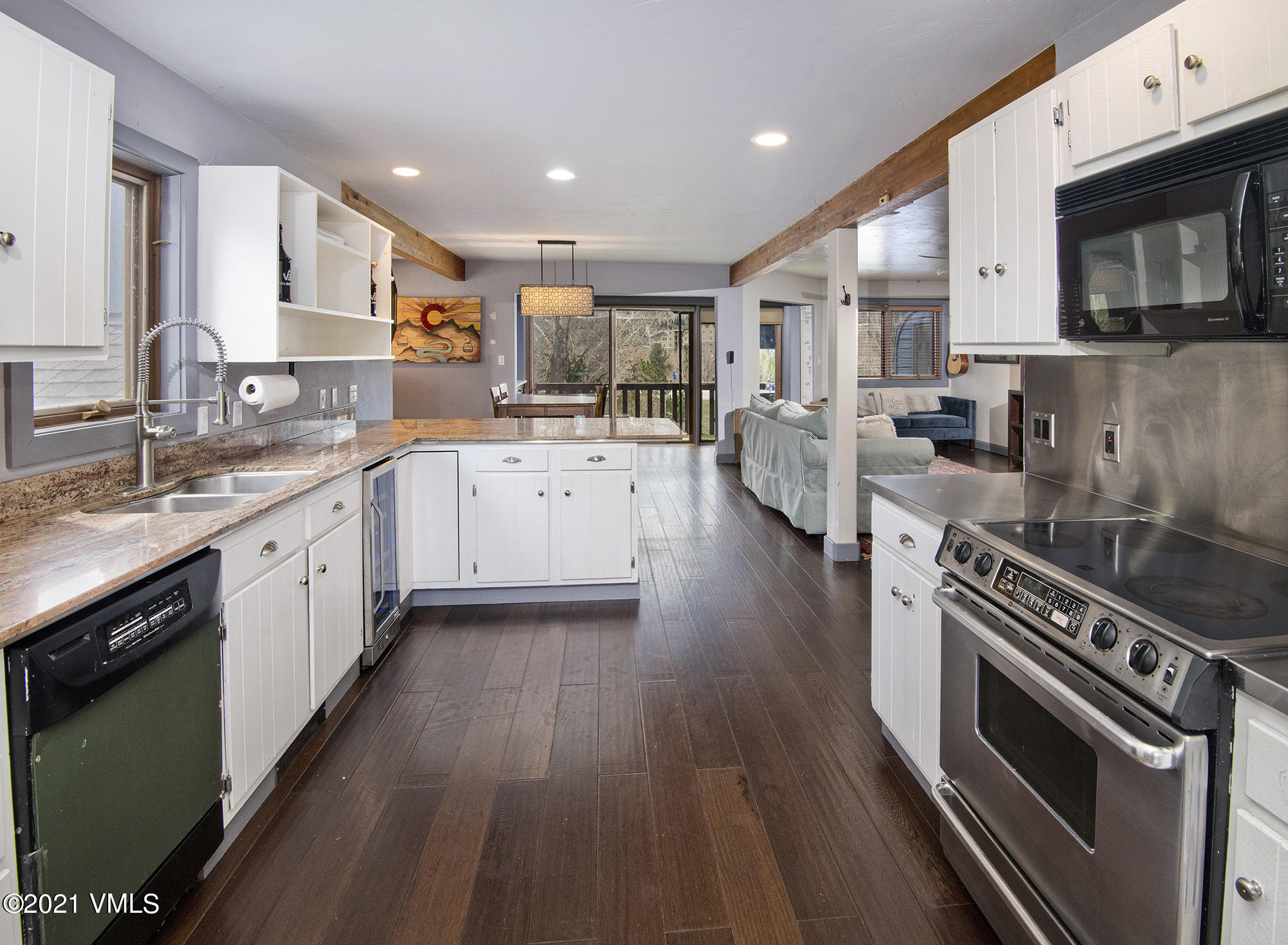 a open kitchen with stainless steel appliances granite countertop a lot of counter space and wooden floors