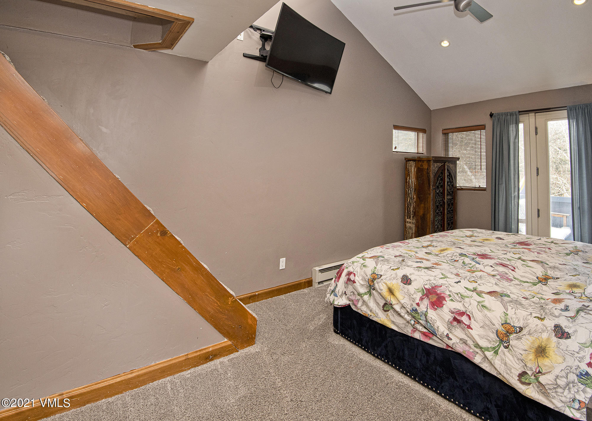 211 Nottingham Road, Unit F Avon, CO 81620 - Photo 13 of 26 a bedroom with a bed and a flat screen tv