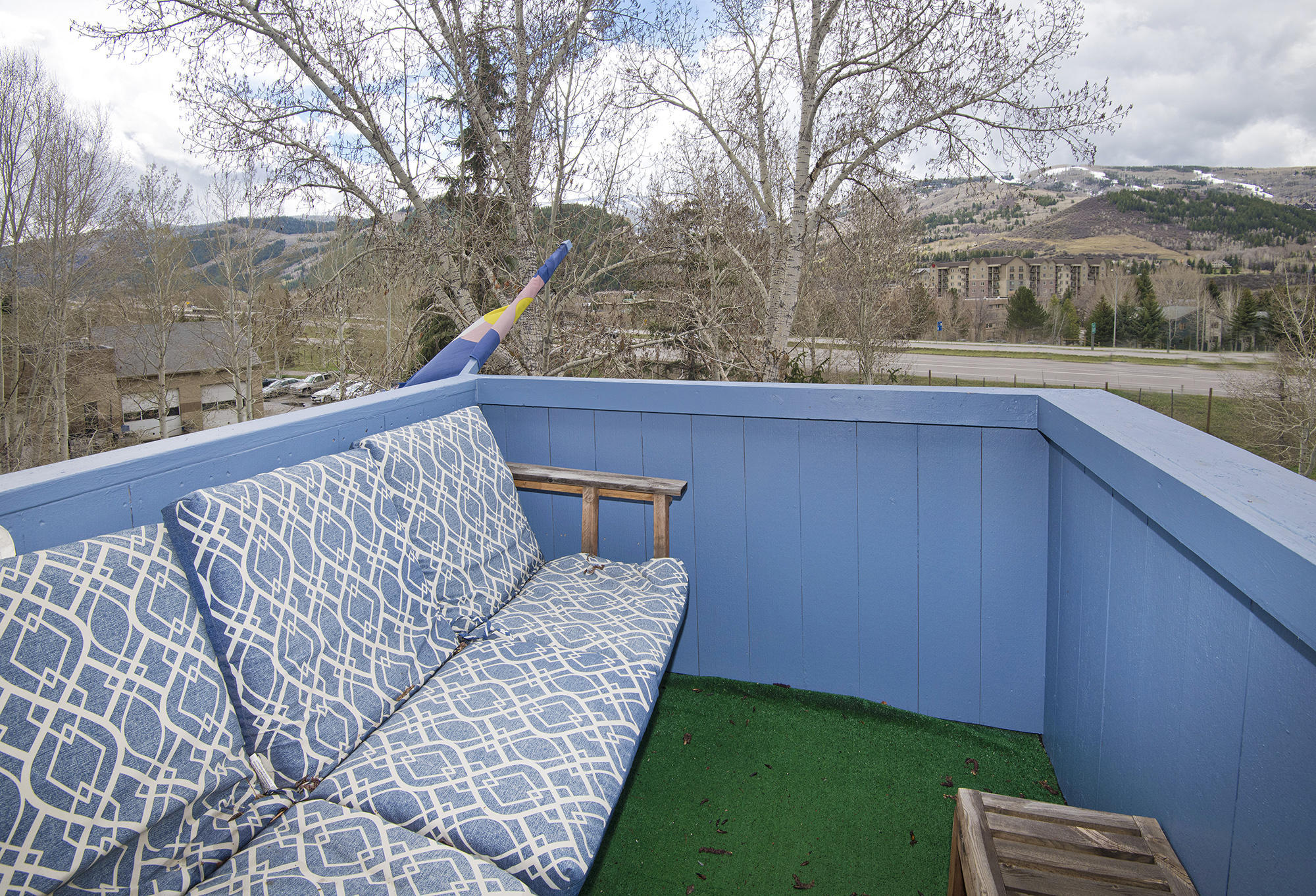 211 Nottingham Road, Unit F Avon, CO 81620 - Photo 20 of 26 a view of a backyard with wooden floor and lake view