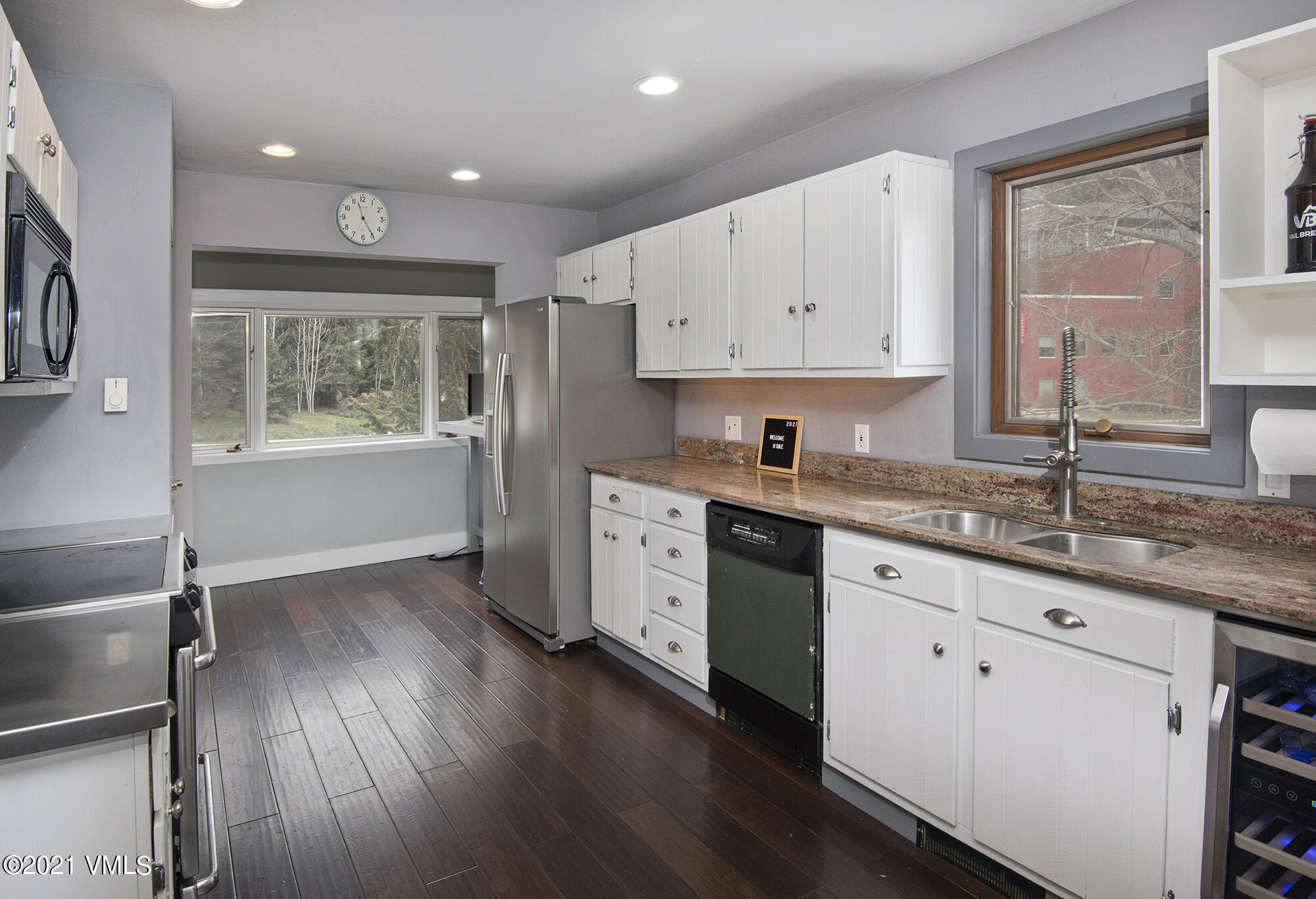 211 Nottingham Road, Unit F Avon, CO 81620 - Photo 3 of 26 a kitchen with granite countertop a sink cabinets and wooden floor